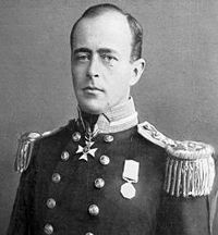  Man with receding hairline, looking left, wearing naval uniform with medals, polished buttons and heavy shoulder decorations