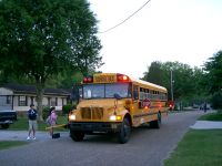 The crossing arm on the front bumper prevents students from entering a blind zone caused by hood of the bus.