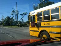 A school bus photographed with its stop arm deployed.