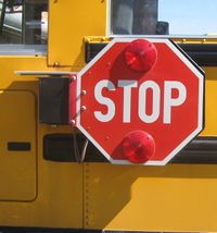 A school bus stop arm in the stowed position