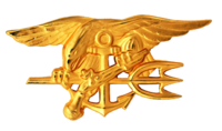 A gold image depicting an eagle perched on an anchor, clutching a trident with one claw and a gun in the other.