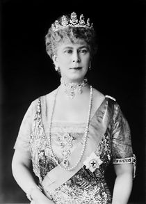 Lady in tiara and gown wearing a choker necklace and a string of pearls