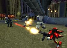 The hedgehog from the cover shoots a single bullet from a machine gun-like firearm at a human soldier who attempts to do the same. The setting is a dissheveled city street at night with tall buildings surrounding the area and an elevated highway overhead.