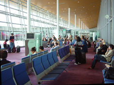 Departure lounge with large windows for light and aircraft viewing.