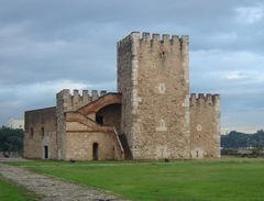 A low, two-storey building with a crenellated frontage. A four-storey crenellated tower is in the centre of the frontage.