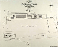 The churchyard, a large near-rectangle, runs east–west. A row of five buildings lines its north side, between it and the east–west Angel Alley. St. George's Church is at the churchyard's southwest corner.