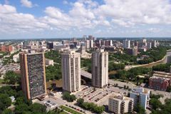 Skyline of an urban area with several tall skyscrapers surrounded by trees