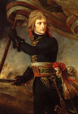 Three-quarter length depiction of Bonaparte, with black tunic and leather gloves, holding a standard and sword, turning backwards to look at his troops