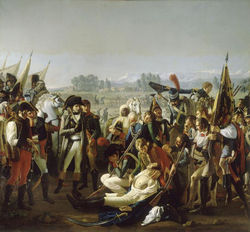 Oil painting featuring Napoleon in the foreground being presented by a soldier the body of Desaix. Desaix is wearing a white shirt and his chest is exposed to show the wound. Numerous and curious bystanders surround the scene.