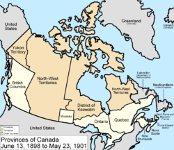 alt=Map of the country of Canada on June 13, 1898, depicting the larger postage stamp sized province of Manitoba along with the provinces of Ontario, Prince Edward Island, Quebec, New Brunswick, British Columbia and Nova Scotia, in the colour white. The disputed area between Manitoba and Ontario is resolved, Ontario expands west to the Lake of the Woods and north to the Albany River. The North-West Territories is separate from the District of Keewatin. Territories are depicted in the colour pink; the northern arctic islands are a part of the NWT.  The District of Keewatin now has a geographically shaped border to encompass the eastern borders of the newly formed provisional districts of the NWT. Yukon Territory is now formed from the NWT.  The area called Newfoundland, Labrador, and Alaska are depicted in bluish grey colour, and are not a part of Canada.