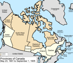 Map of the country of Canada on May 23, 1901, depicting the larger postage stamp sized province of Manitoba along with the provinces of Ontario, Prince Edward Island, Quebec, New Brunswick, British Columbia and Nova Scotia, in the colour white. The disputed area between Manitoba and Ontario is resolved, Ontario expands west to the Lake of the Woods and north to the Albany River. The North-West Territories is separate from the District of Keewatin north of Manitoba. Territories are depicted in the colour pink; the northern arctic islands are a part of the NWT.  The District of Keewatin now has a geographically shaped border to encompass the eastern borders of the newly formed provisional districts of the NWT. Yukon Territory is now formed from the NWT, and is expanded.  The area called Newfoundland, Labrador, and  Alaska are depicted in bluish grey colour, and are not a part of Canada.