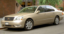 Front quarter view of sedan parked on a street.