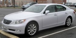 Angled side profile of sedan in a parking lot.