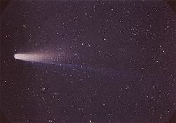 A color image of Comet Halley, shown flying to the left aligned flat against the sky