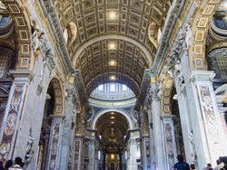  This photo of the interior reveals the near details of the arched ceiling which is divided into square coffers. The changes that Maderno made to the axis and width can be seen clearly in this picture.