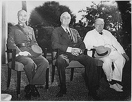 Three men, Chiang Kai-shek, Roosevelt and Churchill, sitting together elbow to elbow