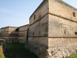 A three-storey stone structure with smooth walls and a roughly cut base. The walls are angular and have openings.