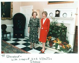 Thatcher and Nancy Regan stand together in a room containing antique furniture and flowers. A handwritten note at the bottom of the photograph reads "To Margaret—with respect and affection, Nancy."