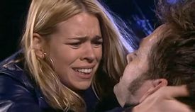 Rose Tyler (Billie Piper) cradles a dying Doctor (David Tennant) after he has been shot by a Dalek extermination ray.