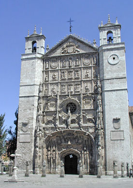 A tall stone building, topped with a cross.