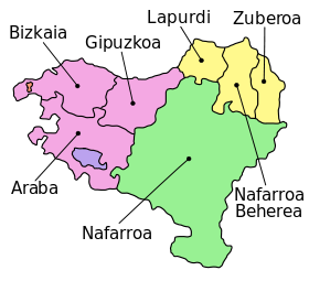 The seven provinces of the Basque Country, as claimed by certain Basque sectors, span France (light yellow) and Spain (rest of the map). The enclaves of Valle de Villaverde and Treviño are pictured in red and blue, respectively. Names on this map are in Basque.