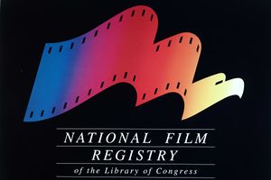 The image includes a logo on a black background. The logo looks like a film reel and changes from left-to-right to an eagle. The logo is multi-colored and below it is the phrase "National Film Registry of the Library of Congress".