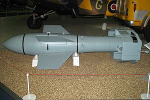 A grey missile sitting on a light-colored floor