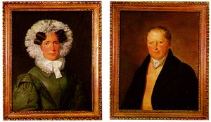 At left, a painted portrait of a woman in a black dress with a frilled hood and ruffled collar. At right, a painted portrait of a man in a black coat wearing a cravat.