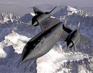 Dryden's SR-71B Blackbird, NASA 831, slices across the snow-covered southern Sierra Nevada Mountains of California after being refueled by an Air Force tanker during a 1994 flight. SR-71B was the trainer version of the SR-71. Notice the dual cockpit to allow the instructor to fly the airplane.