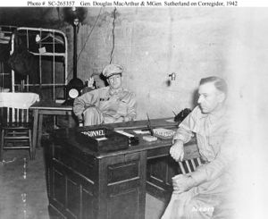 Two men sitting at a desk.