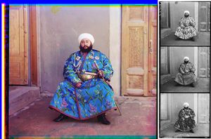 A large color photograph abutting (to its right) a column of three stacked black-and-white versions of the same picture.  Each of the three smaller black-and-white photos are slightly different, due to the effect of the color filter used.  Each of the four photographs differ only in color and depict a turbaned and bearded man, sitting in the corner an empty room, with an open door to his right and a closed door to his left.  The man is wearing an ornate full-length blue robe trimmed with a checkered red-and-black ribbon.  The blue fabric is festooned with depictions of stems of white, purple, and blue flowers.  He wears an ornate gold belt, and in his left hand he holds a gold sword and scabbard. Under his right shoulder strap is a white aiguillette; attached to his robe across his upper chest are four multi-pointed badges of various shapes, perhaps military or royal decorations.