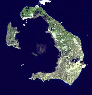 A larger, half-moon shaped  island with a smaller one.