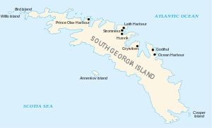  Outline of a long, narrow irregular-shaped island with small islands around its coasts. Thr main island is labelled "South Georgia", and various place names are shown on its north coast including Stromness Husvik and Grytviken.