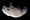 An irregularly shaped body is half illuminated from the bottom. The terminator runs from the left to right. The surface is covered by numerous craters.