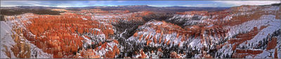 Landscape with red and pink rocks with some snow