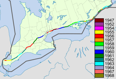 A map of Highway 401 within southern Ontario with various sections coloured according to when they opened, as noted in the legend