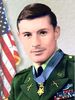 Head and shoulders of a white man with brown hair wearing a green military jacket with ribbon bars on the left breast and a star–shaped medal hanging from a blue ribbon around his neck.