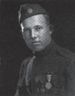 Head and shoulders of a young man in a military uniform with an array of medals on his chest and a garrison cap with a "US" button.