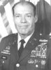 A black and white photo of older balding white man in his dress military uniform without a hat