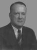 Head and shoulders of a middle-aged white man in a suit and striped tie.