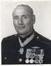 A black and white image of Howard wearing his dress blue uniform with medals and no hat. His Medal of honor can be seen around his neck and he is turned slightly to the left.