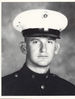 A black and white photo of a young white man in his military dress uniform with hat