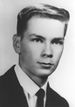 A black and white headshot of LaPointe in a suit and tie