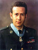 A color image showing Penry from the waist up in his military dress uniform with ribbons. His Medal of Honor is visible around his neck.