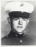 A black and white head shot image showing Smedley in his military dress uniform with hat.