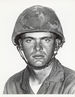 A black and white headshot of Worley wearing his combat uniform with Kevlar helmet.