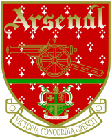 A line drawing of a cannon facing left, above which is the word "Arsenal" upon a red shield. Below the cannon, but still within the shield, is a depiction of a smaller coat of arms. Below the shield is a scroll with the words "Victoria Concordia Crescit" on it.