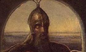 Head and shoulders of bearded man in the gloom, wearing a medieval helmet