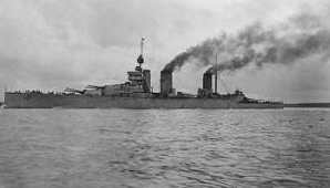 Three-stacked, dark gray warship at sea