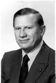 Black and white photo of man in a suit and black tie